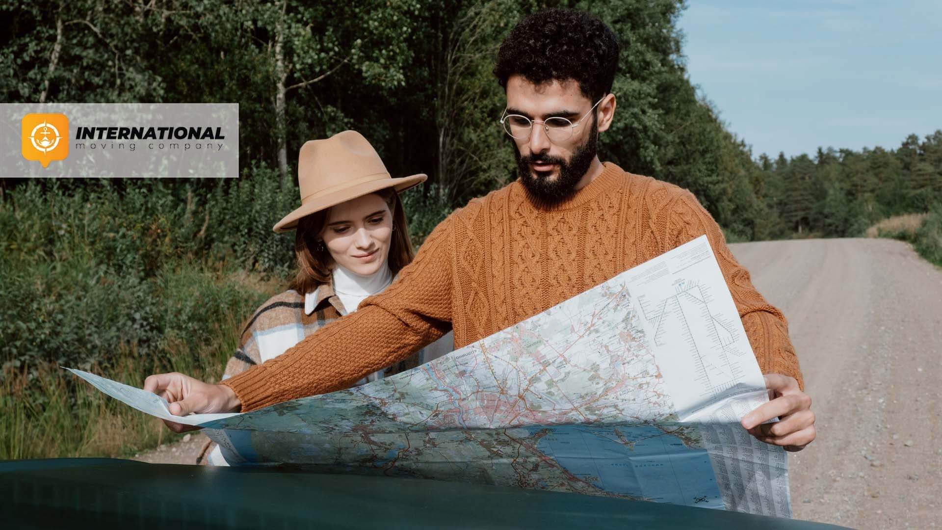 Couple looking at the world map International Moving Company Logo