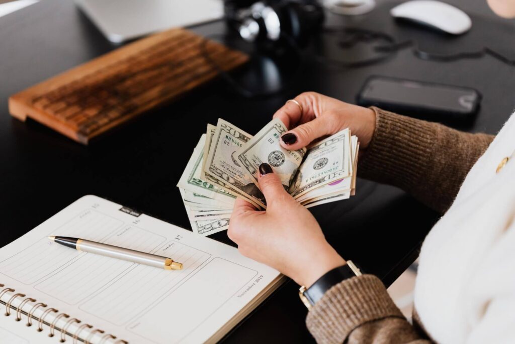 Woman counting money before moving overseas
