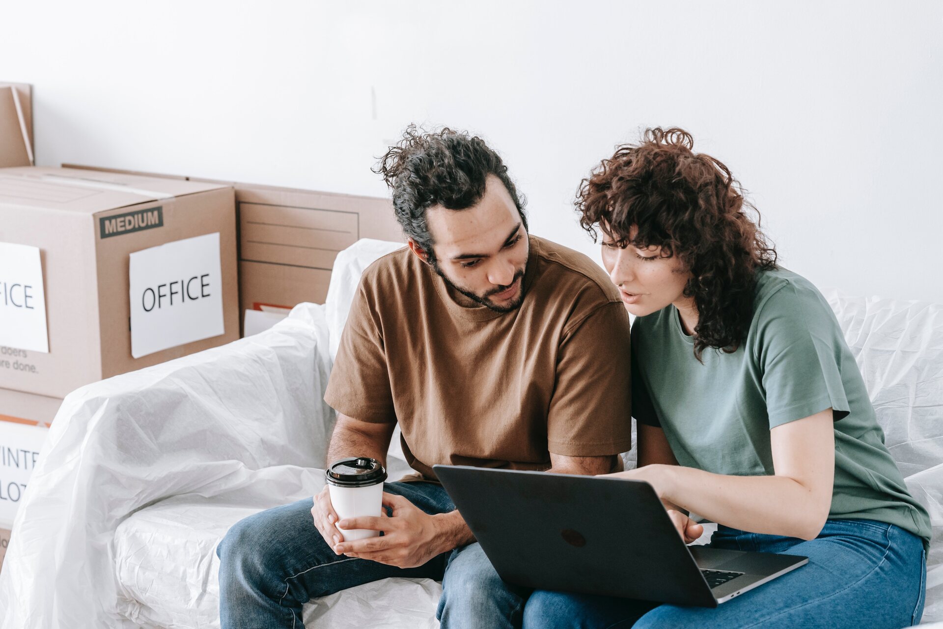 A woman and a man looking at a laptop