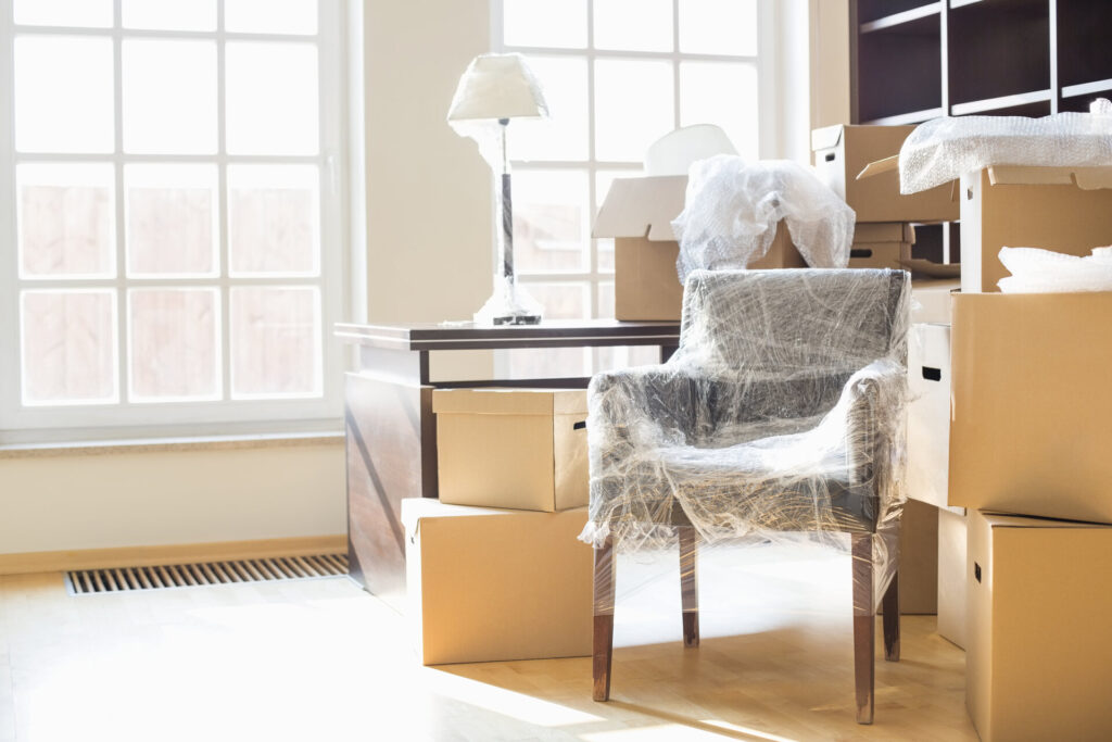 Wrapped chair surrounded by boxes for moving overseas
